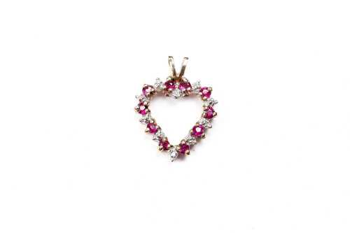 A ruby and diamond pendant in 9 carat yellow gold