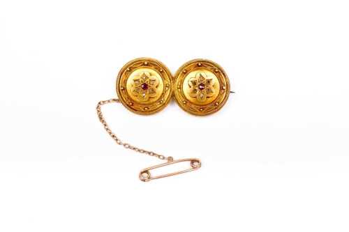 An antique rolled gold garnet and diamond brooch