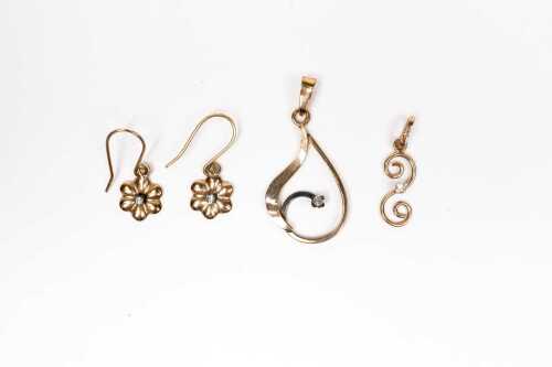 Two diamond pendants and a pair of diamond earrings in 9 carat gold