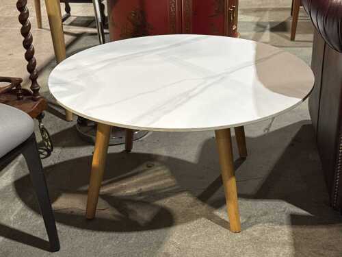 A modern round porcelain top coffee table