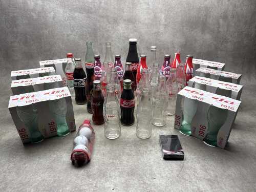 Collection of Coke glass bottles and drinking glasses
