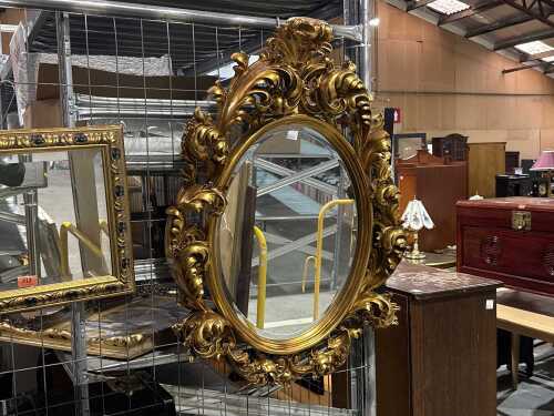 Rooco-style, heavily carved, oval, ornate mirror