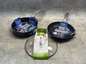 Two fry pans and a lid