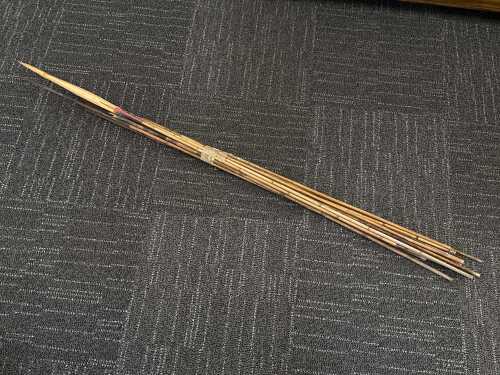 Collection of Papua New Guinea fishing spears with cane shafts and natural fibre bindings