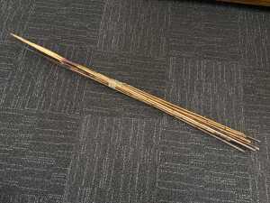 Collection of Papua New Guinea fishing spears with cane shafts and natural fibre bindings