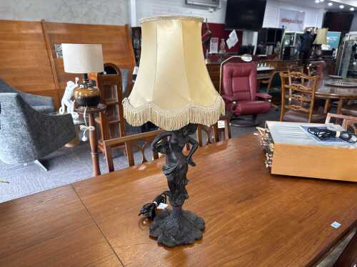 Cast metal figural lamp with caramel fringed fabric shade