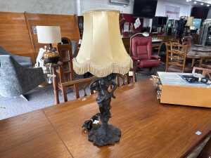 Cast metal figural lamp with caramel fringed fabric shade