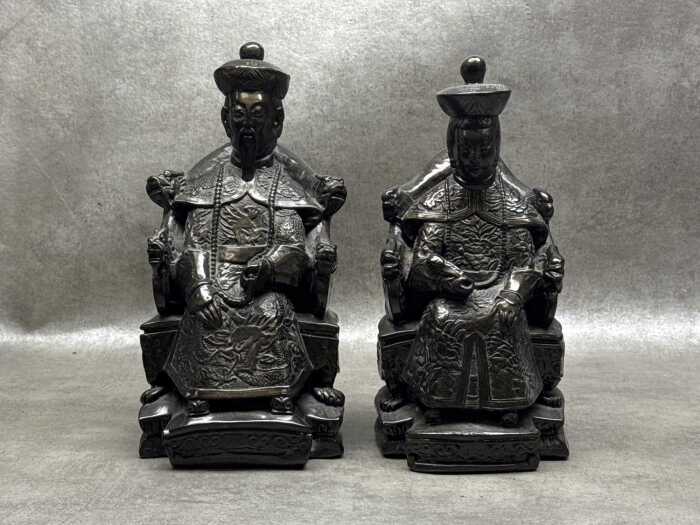 Pair of bronzed resin Chinese seated Emperor and Empress figures