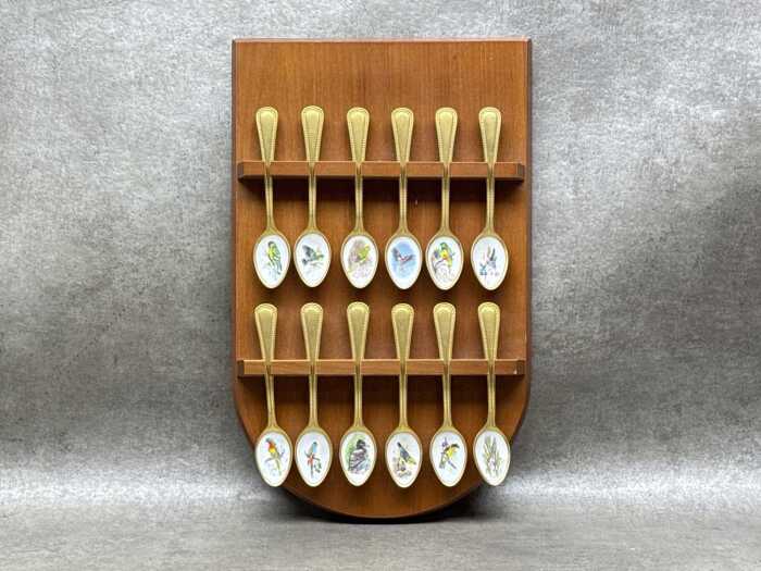 Set of 12 gold plated and enamel spoons with bird designs