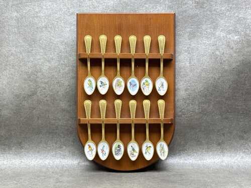 Set of 12 gold plated and enamel spoons with bird designs
