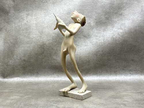 Whimsical resin figure of a boy and a bird on base