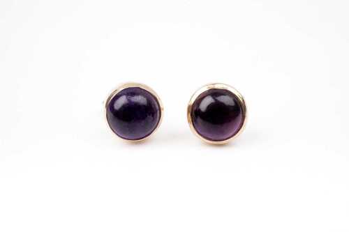 A pair of amethyst studs in 9 carat yellow gold.