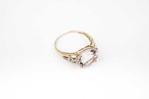 A white quartz and diamond ring in 9 carat yellow gold