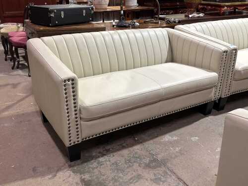 Contemporary cream upholstered two-seater sofa