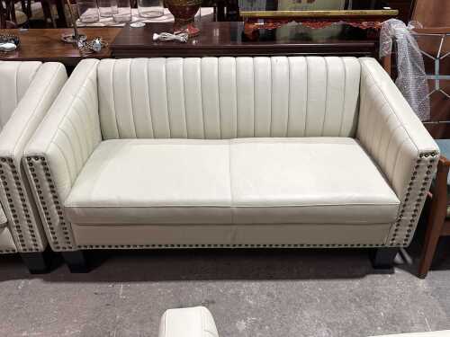 Contemporary cream upholstered two-seater sofa