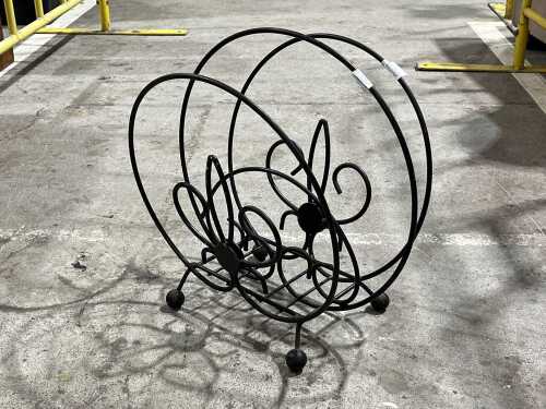 Vintage black metal magazine rack with scrollwork