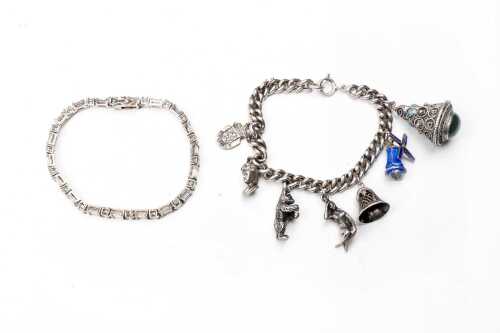 A vintage charm bracelet and cubic zirconia bracelet in silver