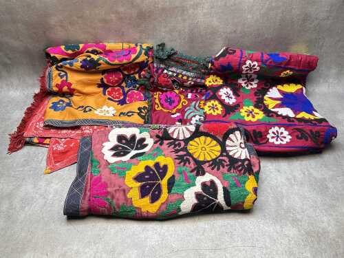 Four embroidered silk wall hangings and throws