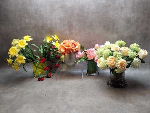 Four potted decorative artificial flowers