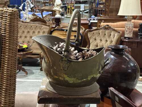 Antique brass coal skuttle with embossed lion head motif