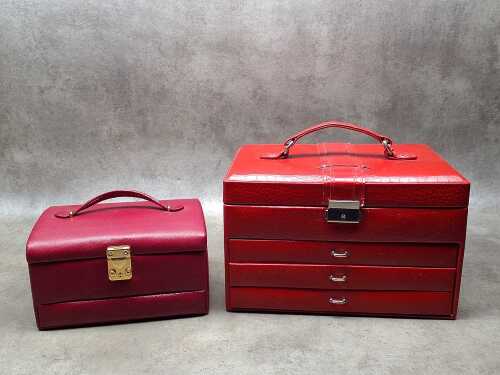 Two red jewellery boxes featuring multiple compartments