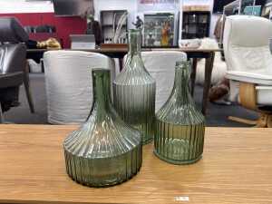 Three contemporary green glass decorator bottles