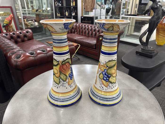 Pair of majolica candle stands with fruit decoration