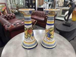 Pair of majolica candle stands with fruit decoration