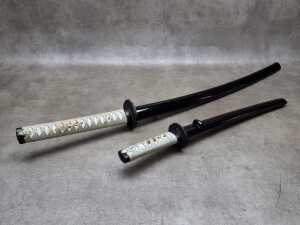 Two decorative Japanese katana swords (requires a weapons-edge license)