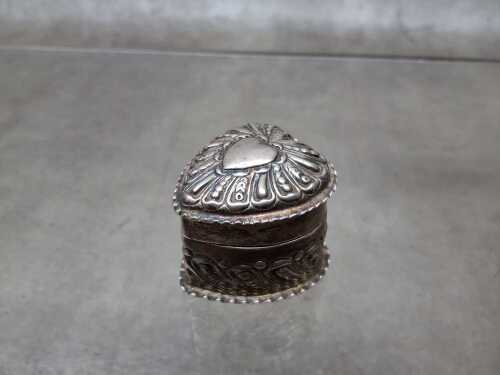 An antique carved box in sterling silver.