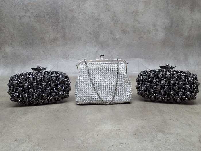 Three clutch purses in white and black tones