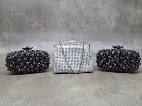 Three clutch purses in white and black tones
