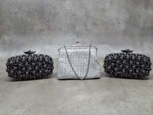 Three clutch purses in white and black tones