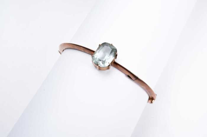 An antique aquamarine bangle in 9 carat rose gold