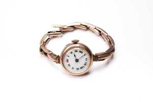An antique watch in 9 carat yellow gold