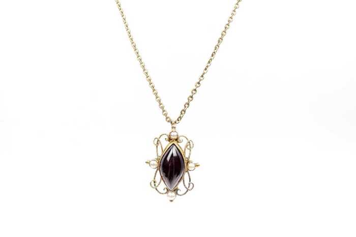 An antique garnet and seed pearl pendant and necklace in rolled gold