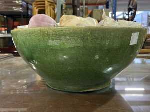 Collection of seashells in a green ceramic bowl. - 3