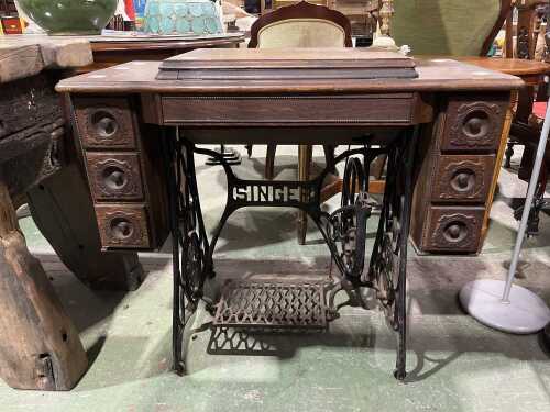 Singer treadle sewing machine in oak cabinet with spinning wheel