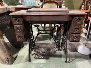 Singer treadle sewing machine in oak cabinet with spinning wheel