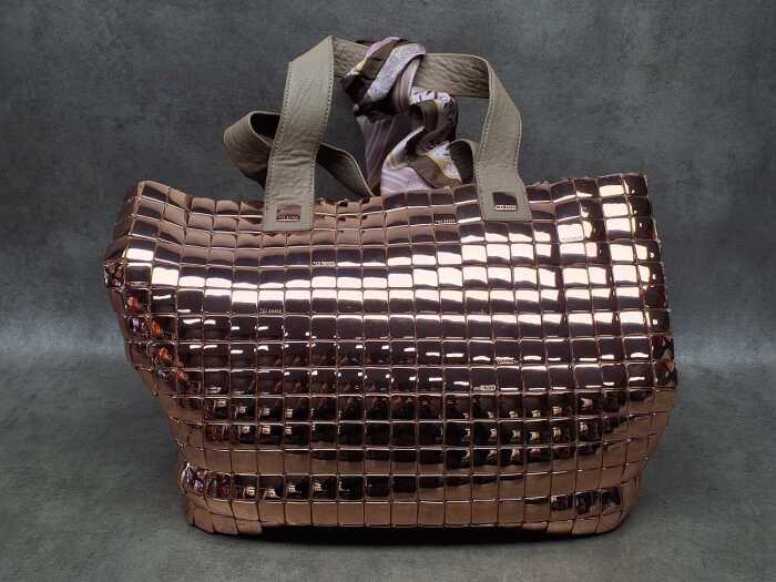 Designer-style rose gold tone handbag with floral lining