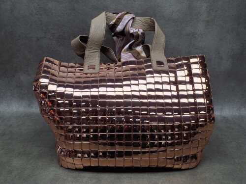 Designer-style rose gold tone handbag with floral lining