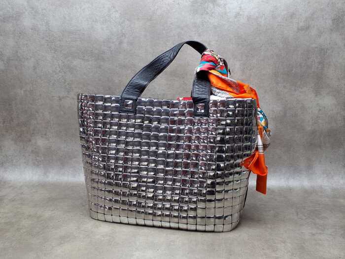 Designer-style silver tone handbag with floral lining