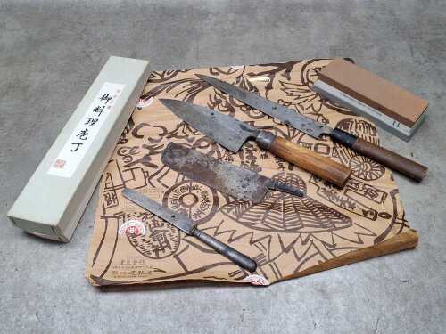 Four vintage Japanese knives, together with whetstone