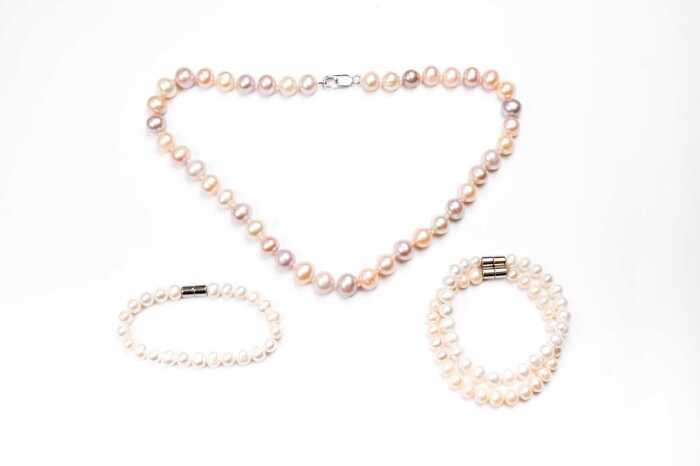 A dyed freshwater pearl necklace with silver clasp and three bracelets