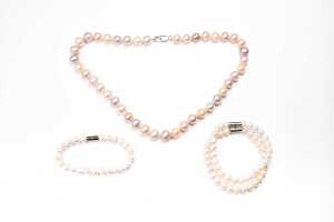 A dyed freshwater pearl necklace with silver clasp and three bracelets