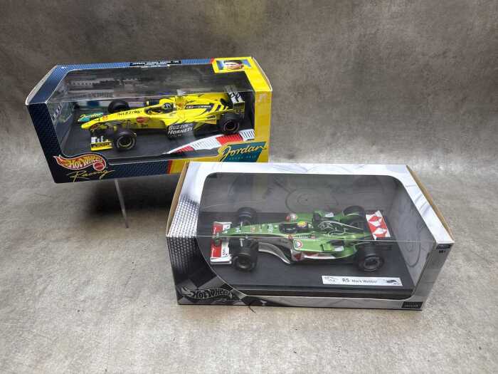 Two Hot wheels model cars, Mark Webber and Damon Hill