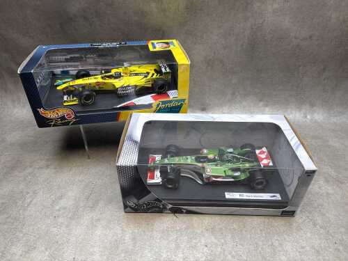 Two Hot wheels model cars, Mark Webber and Damon Hill