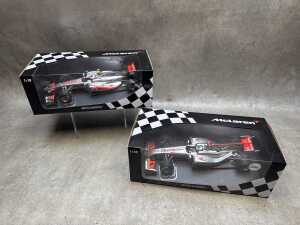 Two McLaren Minichamps 2010 and 2011 model cars