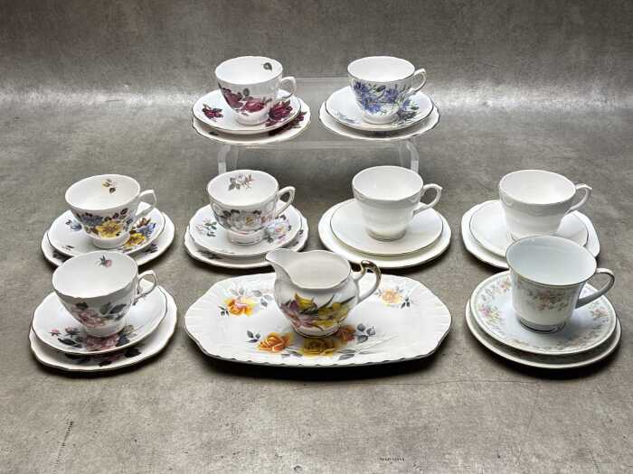 Eight English porcelain trios, together with a sandwich plate and creamer