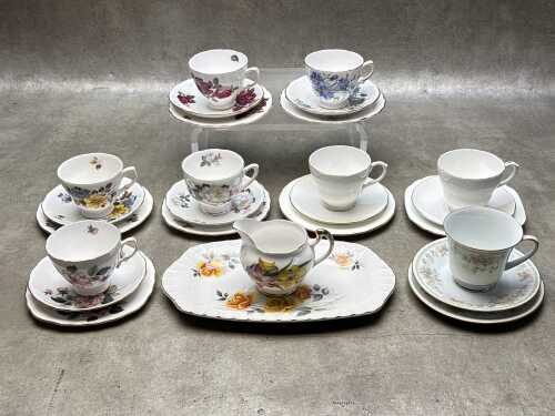 Eight English porcelain trios, together with a sandwich plate and creamer